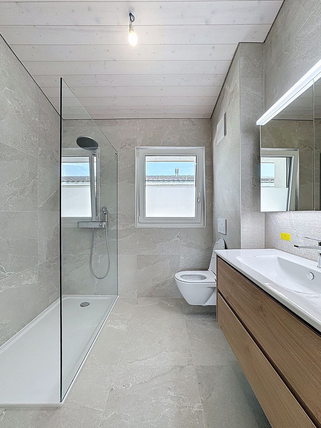 Chambre moderne de la Villa A à Écublens, réalisée par LEGATO EG, entreprise générale de construction active dans la région lausannoise.